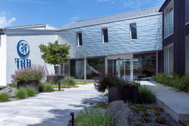 Exterior view of TRB building with modern architecture and landscaped garden.