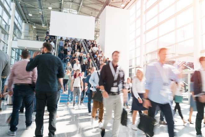 Blurred image of a crowd of business people walking in a modern building
