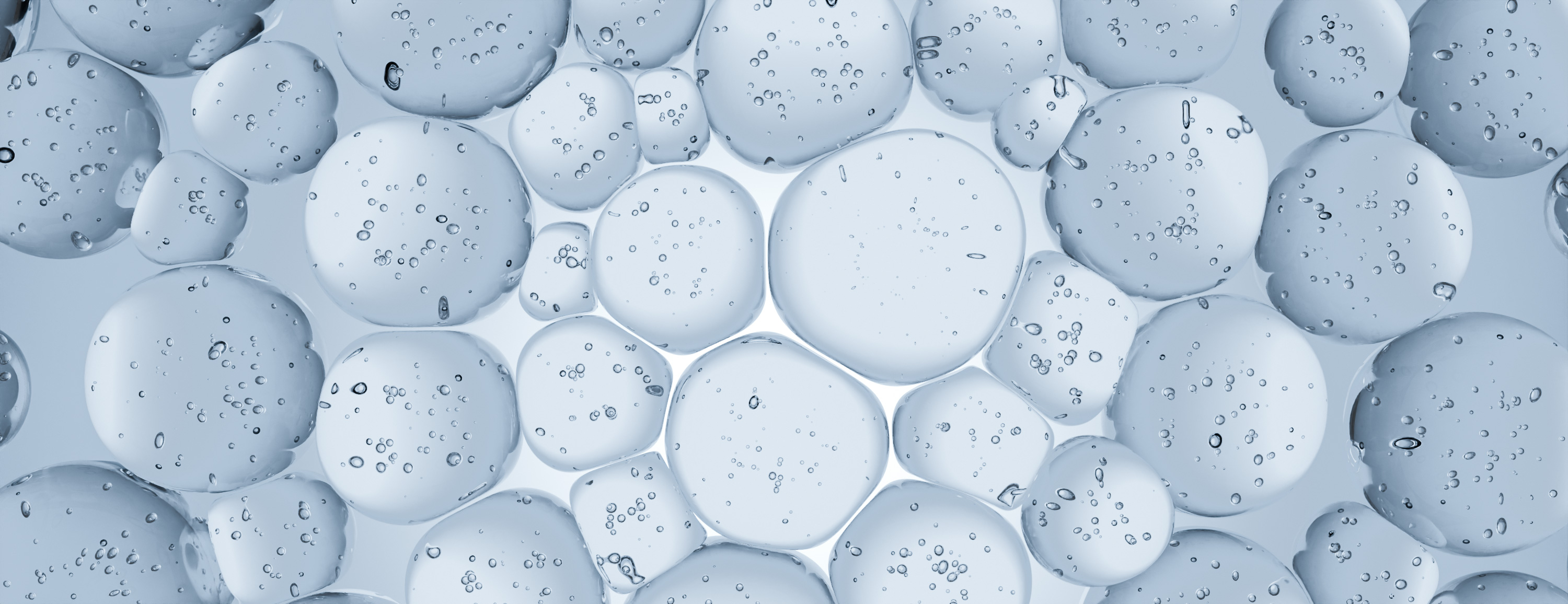 Close-up of water droplets on a surface with varying sizes and shapes