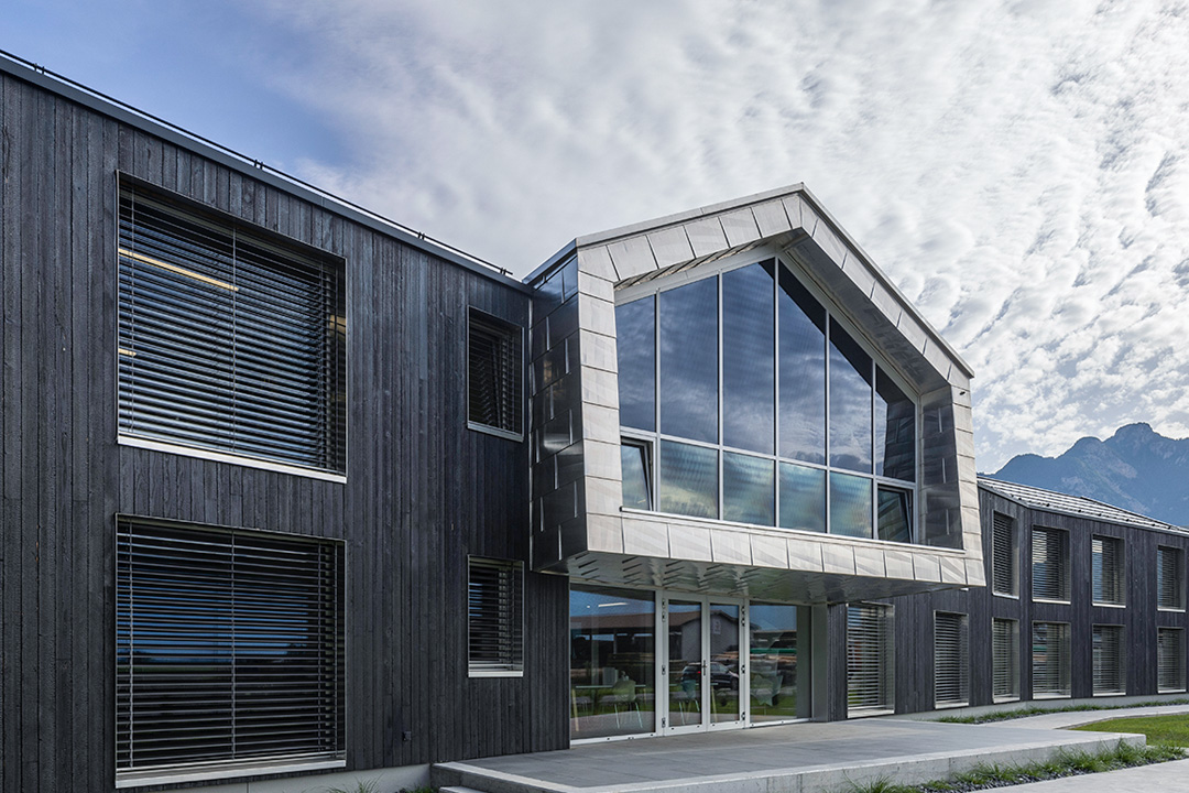 Modern building with large glass windows and wooden exterior