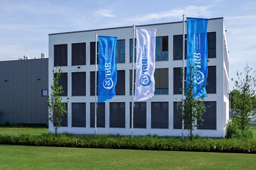 TRB Chemedica building with blue and white flags in front